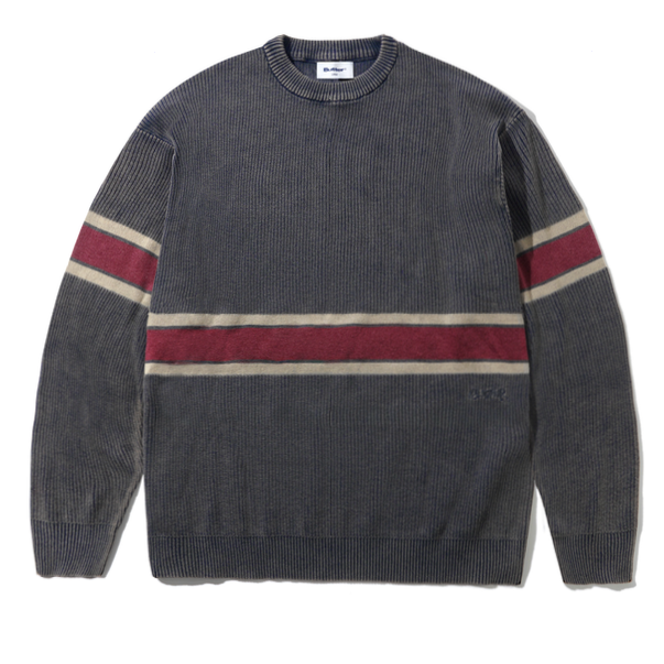 A dark gray ribbed knit crewneck sweater with horizontal stripes in burgundy and beige across the chest and sleeves, laid flat on a white background.
